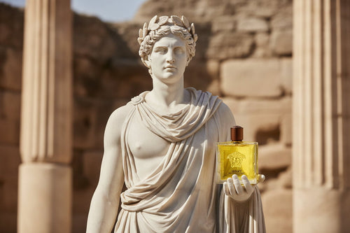 Statue holding a yellow perfume bottle against an ancient stone background
