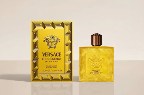 Versace Eros Energy perfume bottle and packaging on a beige background